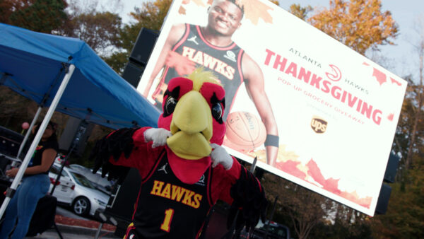 Harry the Hawk participating in the Thanksgiving Pop-Up Grocery Market