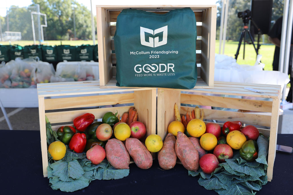 Crates decorated with fresh collard greens, sweet potatoes, and other produce at the McCollum Friendsgiving Pop-Up Grocery Market