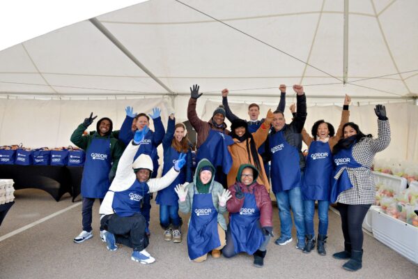 Modivcare corporate team excited for the holiday volunteer opportunity at the Goodr Pop-Up Grocery Market